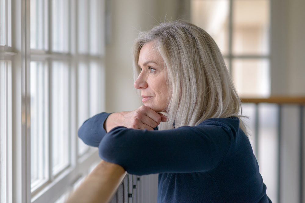 Sad Woman Looking Out Of Window